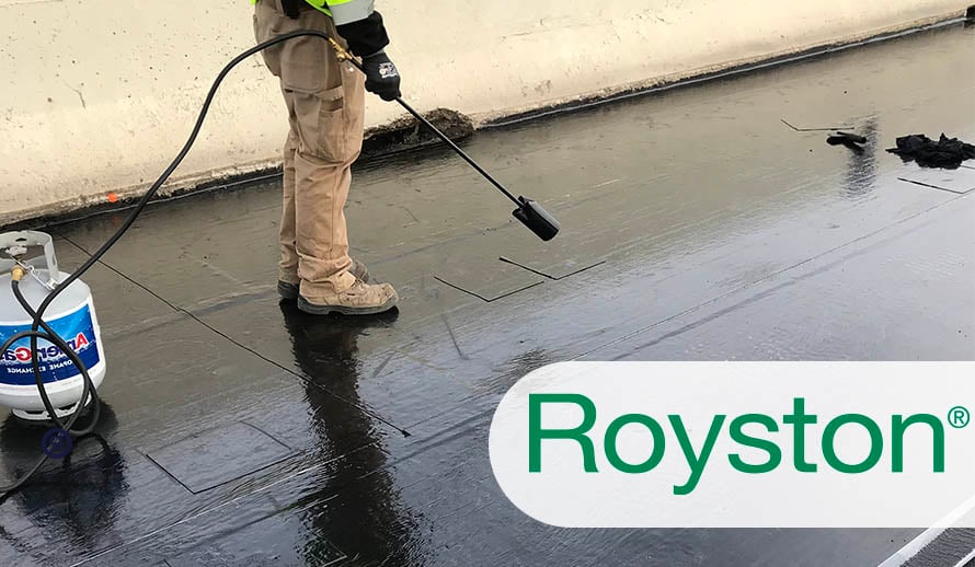 DOT worker applying heat to seal a bridge waterproofing membrane