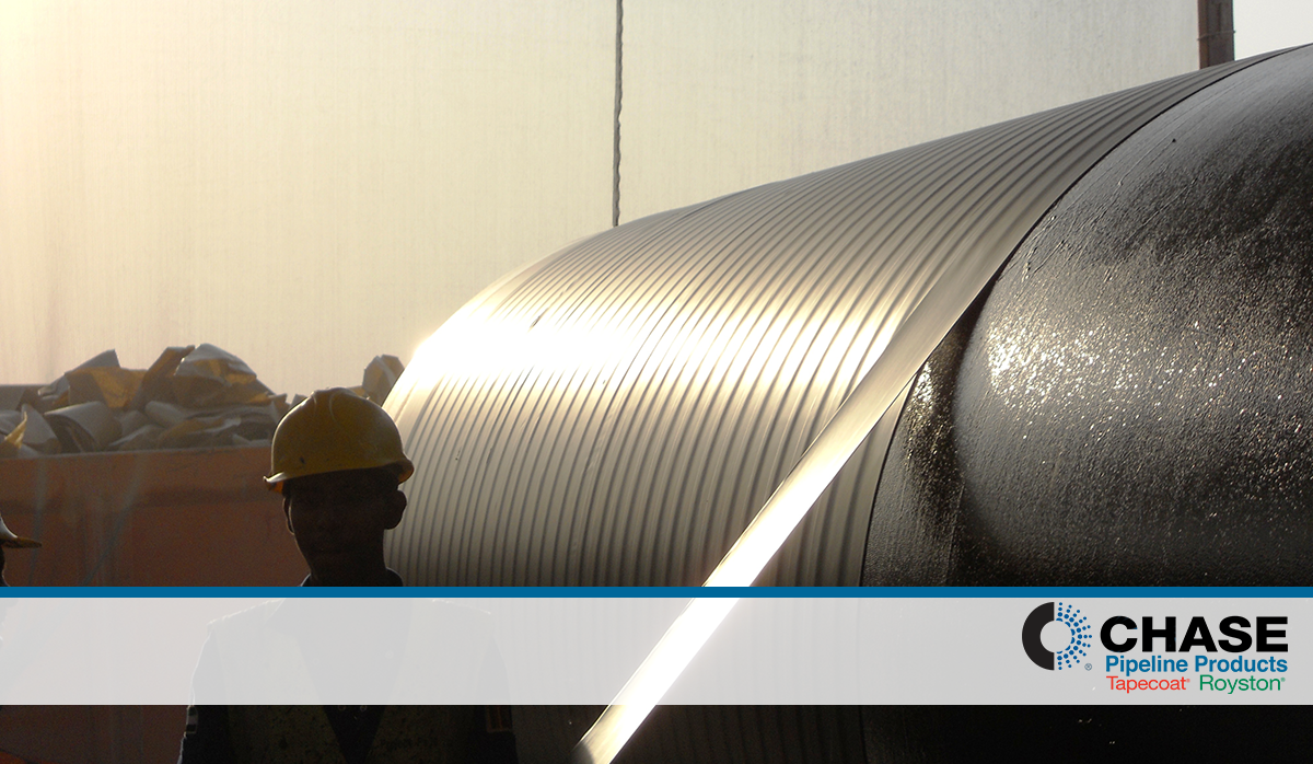 Men applying a protective tape to a gas pipeline