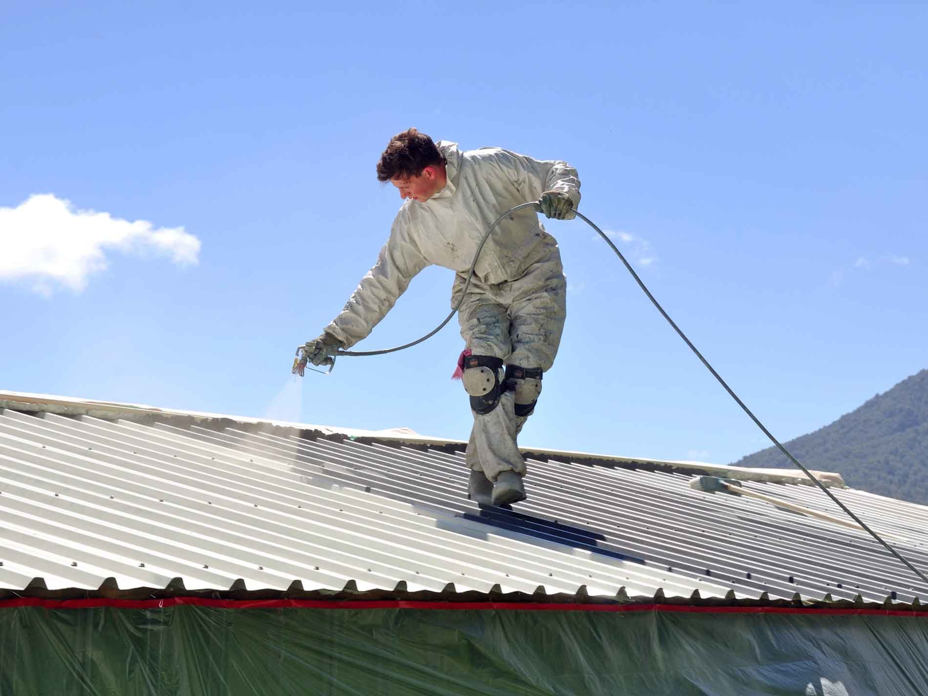 Men-spraying-a-metal-rooftop1