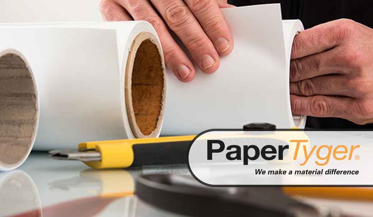Person cutting durable paper