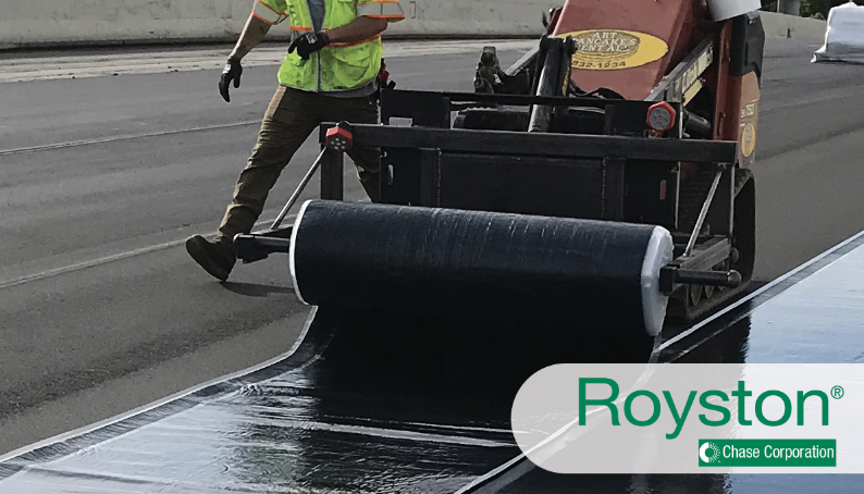 Road construction crew applying rolls of Royston membranes