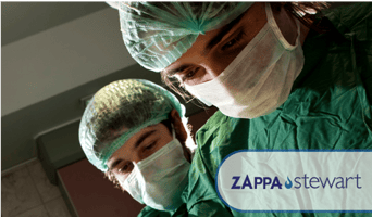 surgeons looking down to patient